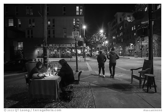 Men playing chess on Telegraph Avenue at night. Berkeley, California, USA (black and white)