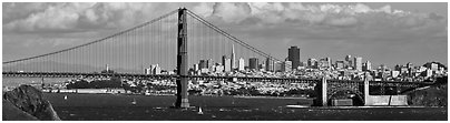 Golden Gate Bridge, and San Francisco city skyline with cloudy sky. San Francisco, California, USA (Panoramic black and white)
