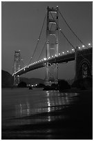 Golden Gate bridge and surf seen from E Baker Beach, dusk. San Francisco, California, USA (black and white)