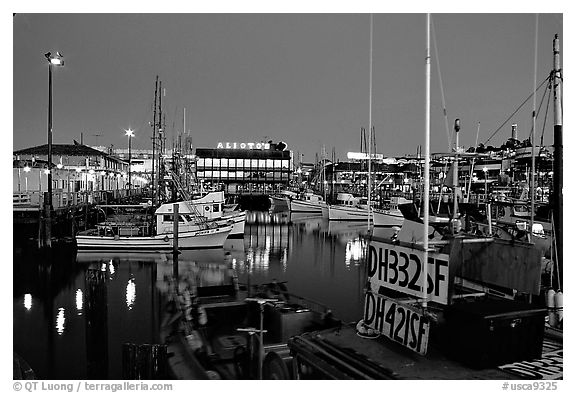 Fishing boat in  Fisherman's Wharf, with Alioto's in the background, dusk. San Francisco, California, USA
