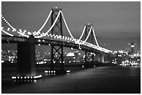 Bay Bridge seen from Treasure Island with defocused lights, sunset. San Francisco, California, USA ( black and white)