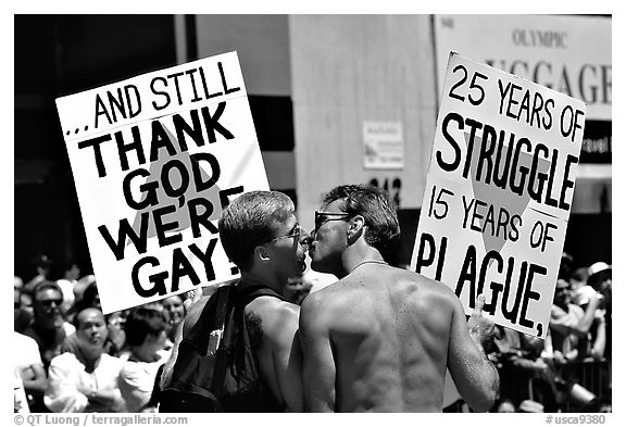 Gay couple with signs during the Gay Parade. San Francisco, California, USA (black and white)