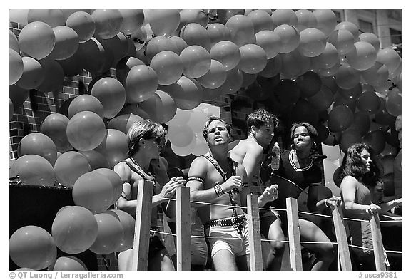 Men with rainbowed ballons on a float during the Gay Parade. San Francisco, California, USA (black and white)
