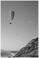 Paragliding above a sea cliff, the Dumps, Pacifica. San Mateo County, California, USA ( black and white)