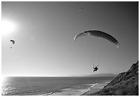 Paragliders soaring above the Ocean, the Dumps, Pacifica. San Mateo County, California, USA ( black and white)
