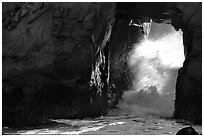 Light and wave through Arch Rock at Pfeiffer Beach. Big Sur, California, USA ( black and white)