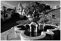 Fountain and chapel, Carmel Mission. Carmel-by-the-Sea, California, USA ( black and white)