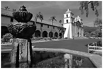 Fountain and Mission Santa Babara, mid-day. Santa Barbara, California, USA (black and white)