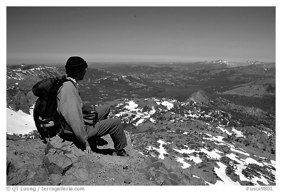 Hiker sitting  on top of Round Top Mountain. Mokelumne Wilderness, Eldorado National Forest, California, USA