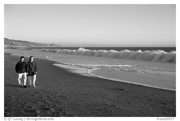 Couple strolling on the beach, late afternoon. Point Reyes National Seashore, California, USA