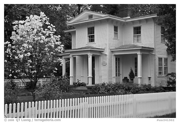White picket fence and house, Essex. Connecticut, USA