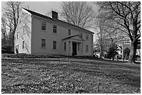 Historic house with early blooms in front yard, Sandwich. Cape Cod, Massachussets, USA ( black and white)