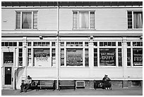 Men sitting in front of candy store, Provincetown. Cape Cod, Massachussets, USA ( black and white)