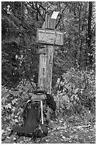 Backpack and marker for last 100 miles, wildest of Appalachian trail. Maine, USA ( black and white)