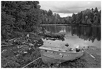 Cove and boat on shore of  Moosehead lake, Lily Bay State Park. Maine, USA ( black and white)