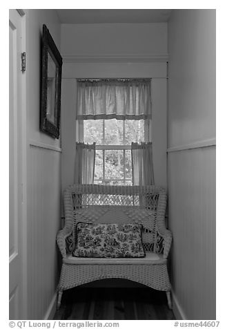 Corridor in inn with chair and window looking out to trees. Maine, USA