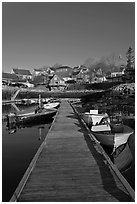Deck, small boats, and houses. Stonington, Maine, USA (black and white)