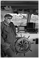 Captain of Isle-au-Haut mailboat aboard boat. Isle Au Haut, Maine, USA ( black and white)