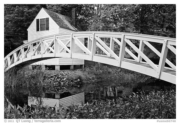 Arched bridge over mill pond. Maine, USA