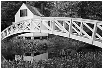Arched bridge over mill pond. Maine, USA (black and white)