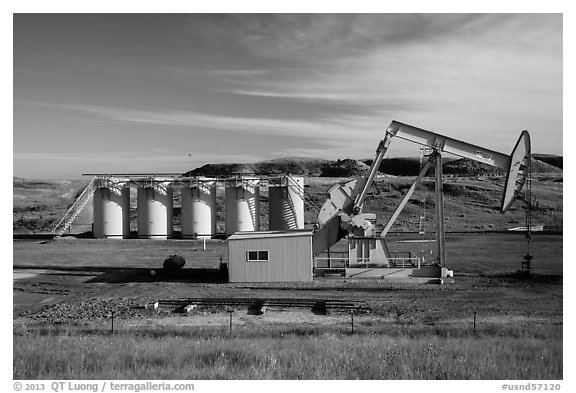 Pumping unit and tanks, oil well. North Dakota, USA (black and white)