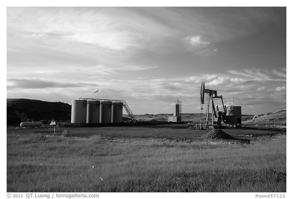 Oil pumpjack and tanks. North Dakota, USA (black and white)