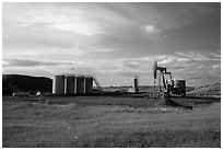 Oil pumpjack and tanks. North Dakota, USA ( black and white)