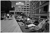 People sunning themselves on the High Line. NYC, New York, USA (black and white)