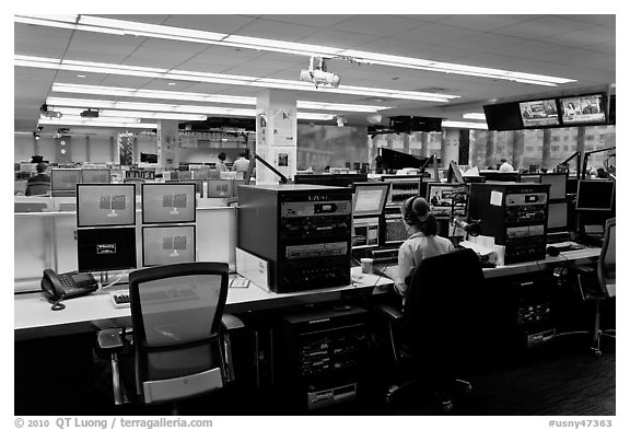 Bloomberg News analyst working in front of many screens. NYC, New York, USA (black and white)