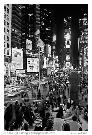 One Times Square at night and Francis Duffy monument. NYC, New York, USA (black and white)