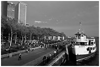 Tour boat along Battery Park, evening. NYC, New York, USA (black and white)