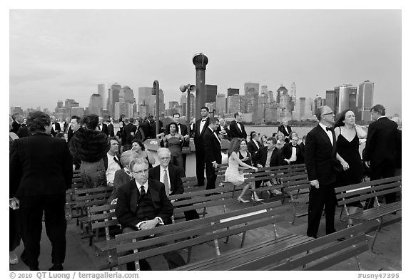 Black Tie gala guests on boat deck, New York harbor. NYC, New York, USA (black and white)