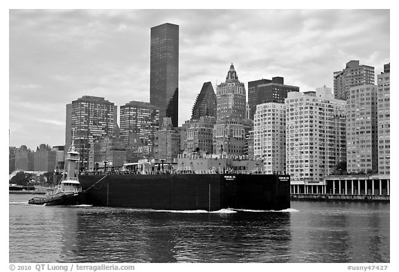 Barge on Hudson River and Manhattan waterfront. NYC, New York, USA