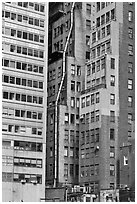 Old high-rise buildings with exterior pipe. NYC, New York, USA ( black and white)