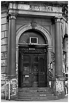 Door of old building on Bowery. NYC, New York, USA (black and white)