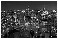 Woman on observation platform of Rockefeller center at night. NYC, New York, USA ( black and white)