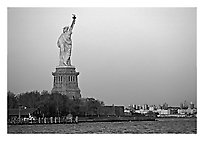 Statue of Liberty and Liberty Island from the back, sunset. NYC, New York, USA (black and white)