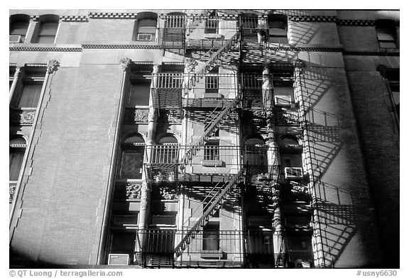 Emergency exit staircases on the side of a building. NYC, New York, USA (black and white)