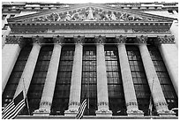 Looking up New York Stock Exchange with flags at half-mast. NYC, New York, USA ( black and white)