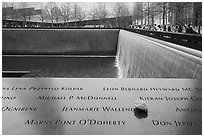 Names incribed on bronze parapets, waterfalls, National September 11 Memorial. NYC, New York, USA ( black and white)