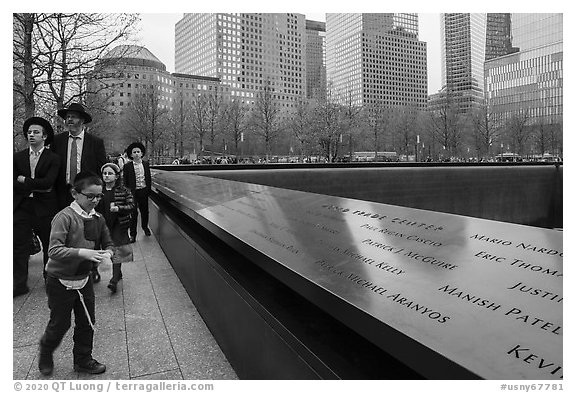 Jewish family walks by 9/11 Memorial. NYC, New York, USA (black and white)