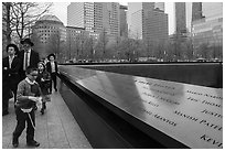 Jewish family walks by 9/11 Memorial. NYC, New York, USA ( black and white)