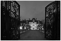 Entrance gate and historic mansion building at night. Newport, Rhode Island, USA (black and white)
