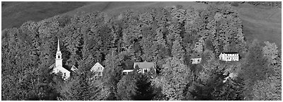 White-steppled church and houses amongst trees in fall foliage. Vermont, New England, USA (Panoramic black and white)