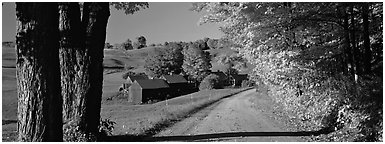 Pastoral view with road and farm in autumn. Vermont, New England, USA (Panoramic black and white)