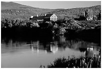 Red barns reflected in Line Pond near Pomfret. Vermont, New England, USA ( black and white)