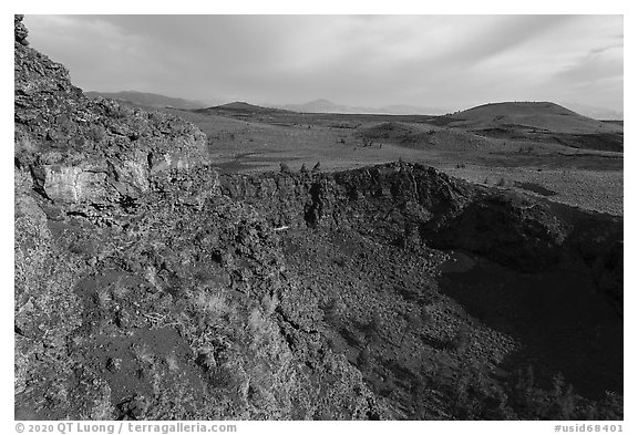 Echo crater with brightly colored rocks and Crescent Butte. Craters of the Moon National Monument and Preserve, Idaho, USA (black and white)