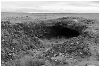 Plain with Bear Trap Cave entrance. Craters of the Moon National Monument and Preserve, Idaho, USA ( black and white)