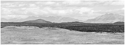 Craters of the Moon Lava Flow and Pioneer Mountains. Craters of the Moon National Monument and Preserve, Idaho, USA (Panoramic black and white)