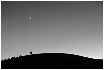 Curve of cinder cone, pastel sky, and moon, Craters of the Moon National Monument. Idaho, USA ( black and white)